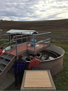 Two people looking into a trickling filter at the Town of Garfield's wastewater treatment plant.